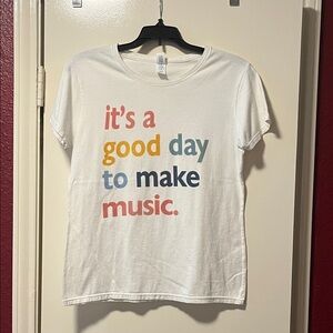 Delta Soft White Tee with Multicolor Text “It’s a good day to make music.”